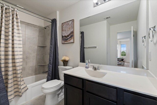 bathroom featuring shower / bath combo, vanity, toilet, tile patterned floors, and visible vents