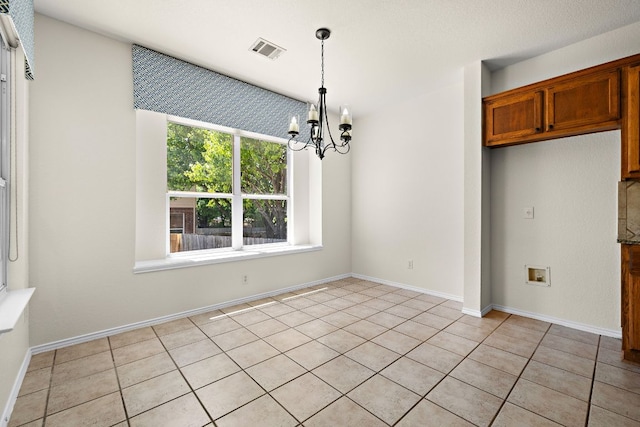 unfurnished dining area with light tile patterned floors, a notable chandelier, and visible vents