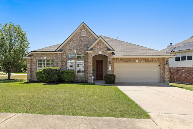 single story home featuring brick siding, a garage, a front lawn, and concrete driveway