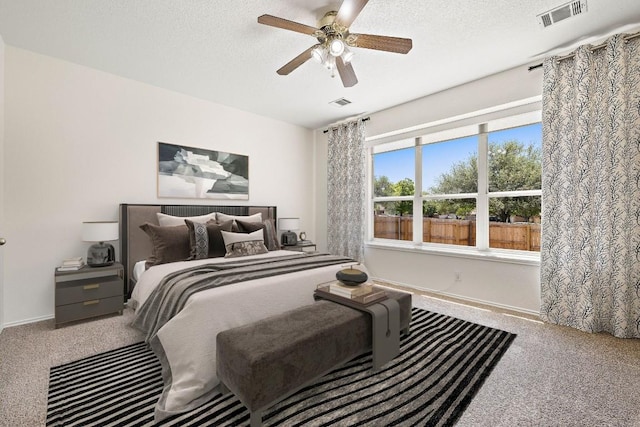 bedroom with baseboards, visible vents, and carpet