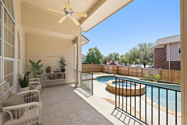 view of swimming pool featuring a patio, a fenced backyard, ceiling fan, and a pool with connected hot tub