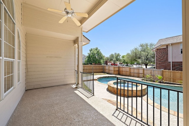 view of pool with ceiling fan, a pool with connected hot tub, a fenced backyard, and a patio area