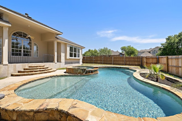 view of swimming pool with a fenced in pool, an in ground hot tub, and a fenced backyard