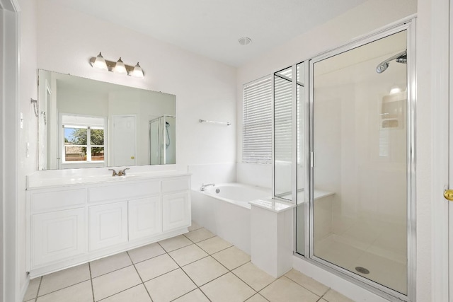 bathroom featuring vanity, a garden tub, tile patterned floors, and a shower stall