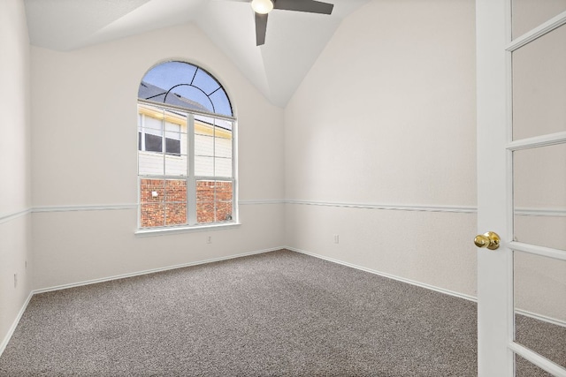 spare room featuring ceiling fan, vaulted ceiling, baseboards, and carpet