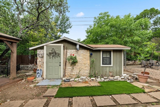 view of outbuilding with an outdoor structure and fence