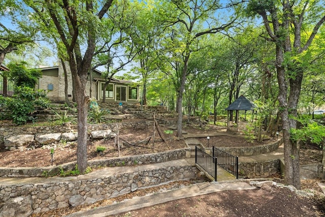 view of yard with fence, a gate, and a gazebo