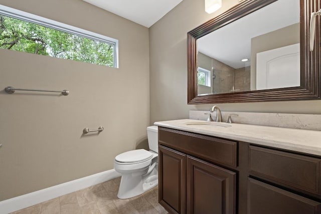 full bathroom with baseboards, vanity, and toilet