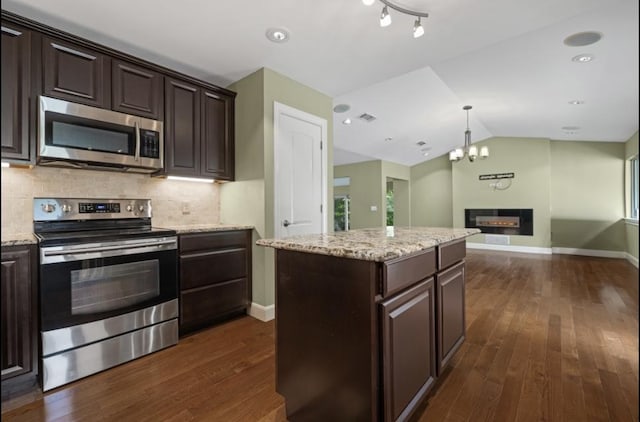 kitchen with dark brown cabinetry, open floor plan, dark wood-style floors, appliances with stainless steel finishes, and backsplash
