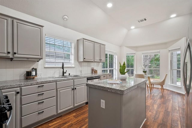 kitchen featuring a sink, decorative backsplash, gray cabinets, and dark wood-style floors