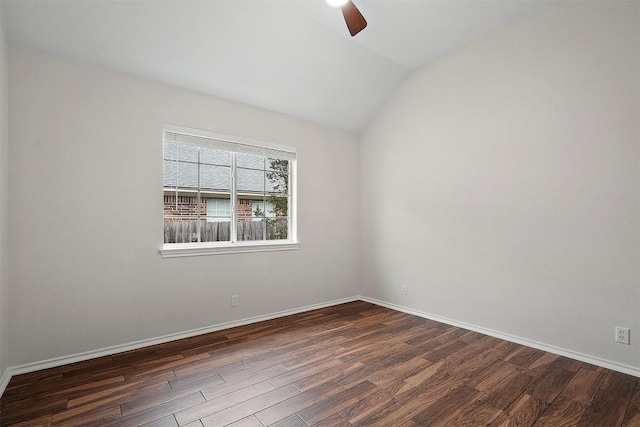 spare room with ceiling fan, dark wood finished floors, baseboards, and lofted ceiling