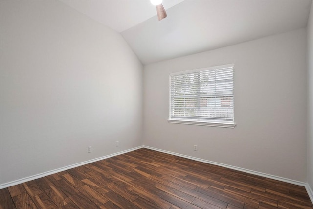 unfurnished room with baseboards, ceiling fan, vaulted ceiling, and dark wood-style flooring