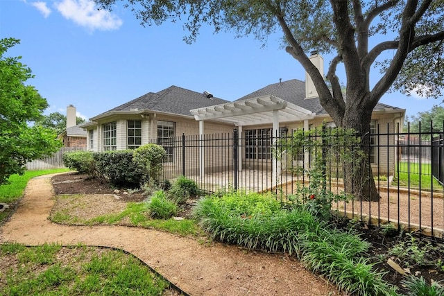 exterior space with fence, a pergola, a shingled roof, brick siding, and a chimney