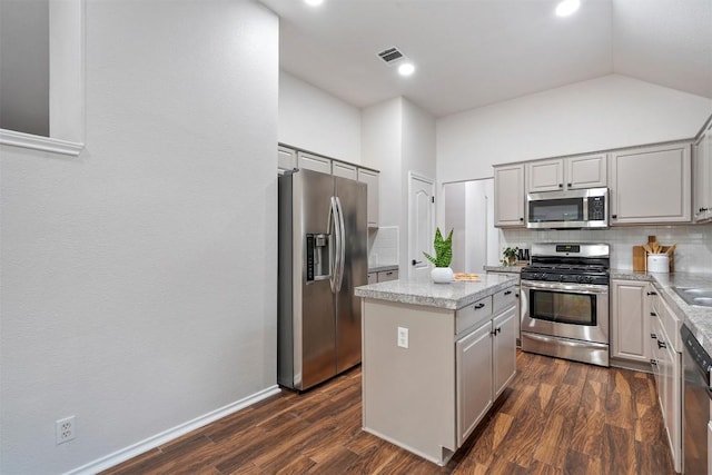 kitchen with gray cabinetry, tasteful backsplash, stainless steel appliances, and visible vents