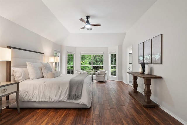 bedroom with dark wood-type flooring, baseboards, visible vents, and vaulted ceiling