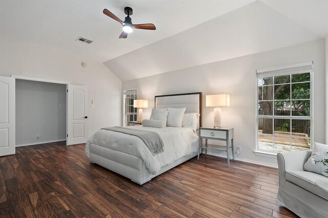 bedroom featuring baseboards, visible vents, wood finished floors, and lofted ceiling
