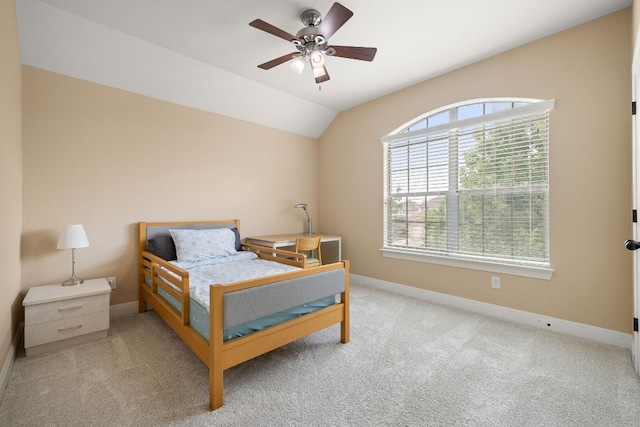 carpeted bedroom with baseboards, ceiling fan, and lofted ceiling