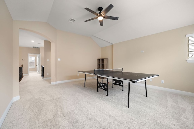 rec room featuring arched walkways, ceiling fan, light carpet, and lofted ceiling