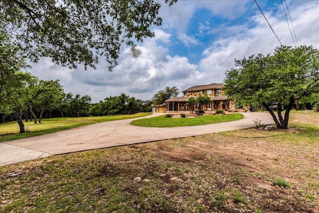 view of yard with curved driveway