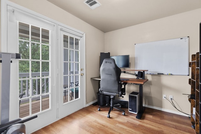 office area with visible vents, baseboards, and wood finished floors