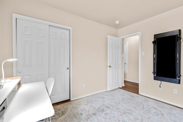 office with baseboards and wood finished floors
