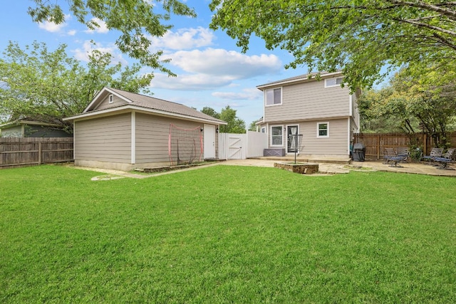rear view of house with a lawn, a gate, and a fenced backyard