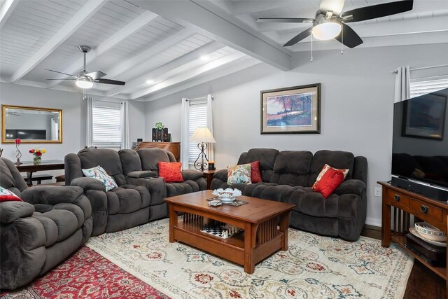 living area with lofted ceiling with beams, ceiling fan, and wood finished floors