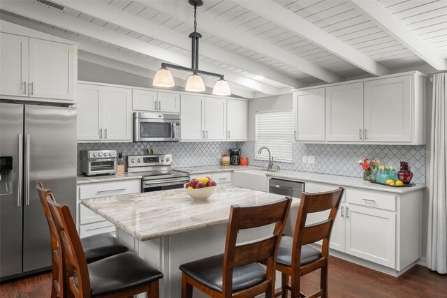 kitchen featuring stainless steel appliances, a sink, dark wood-type flooring, and a toaster