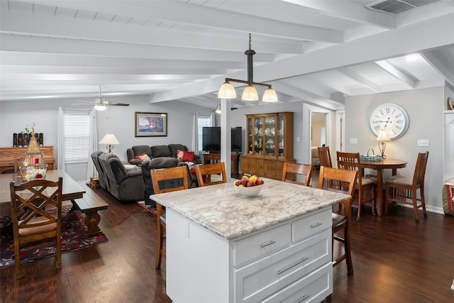 120 Highland Ln, Kingsland, TX 78639 - kitchen featuring a breakfast bar area, dark wood-style floors, a kitchen island, and plenty of natural light
