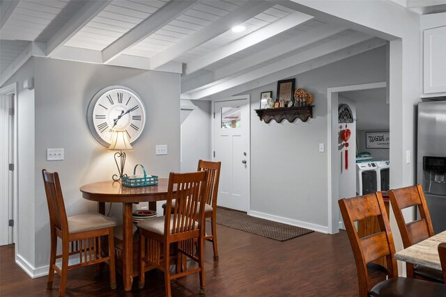 dining space featuring baseboards, vaulted ceiling with beams, dark wood-style floors, and washing machine and clothes dryer