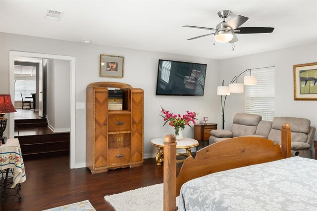 bedroom with visible vents, a ceiling fan, dark wood finished floors, and baseboards