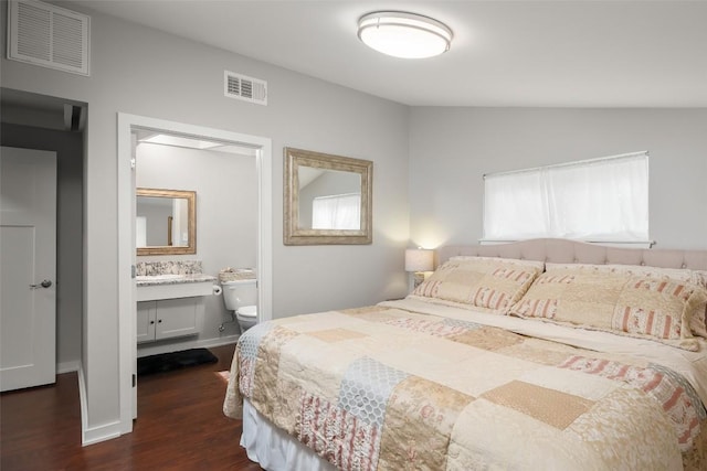 bedroom featuring vaulted ceiling, dark wood-style floors, connected bathroom, and visible vents