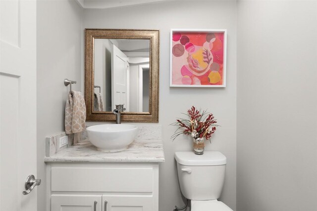 bathroom featuring toilet and vanity