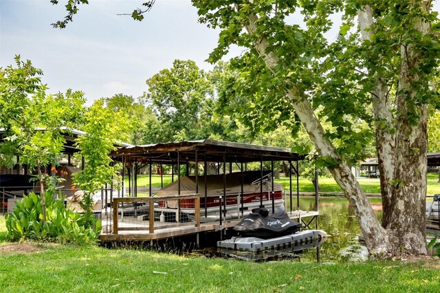 dock area featuring boat lift and a water view