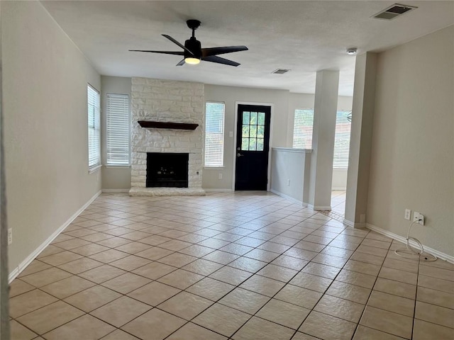 unfurnished living room with ceiling fan, light tile patterned floors, and a wealth of natural light