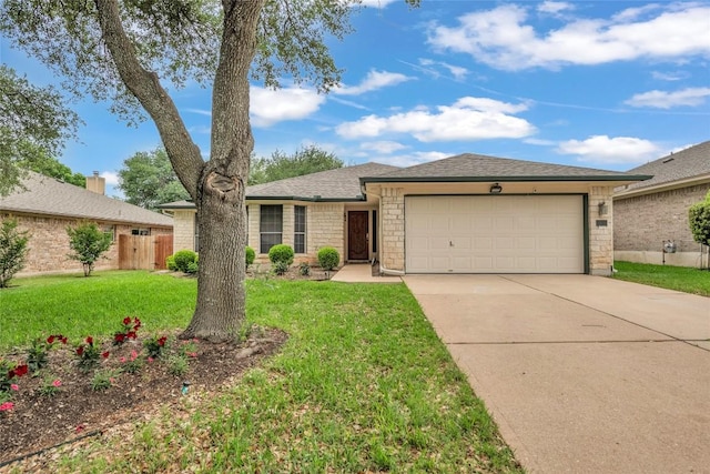ranch-style home featuring a garage, fence, driveway, and a front yard