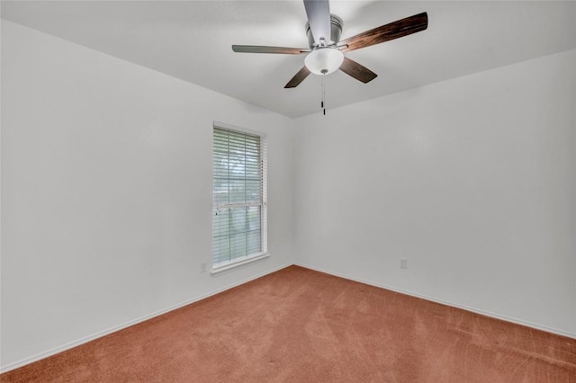 unfurnished room with baseboards, a ceiling fan, and carpet