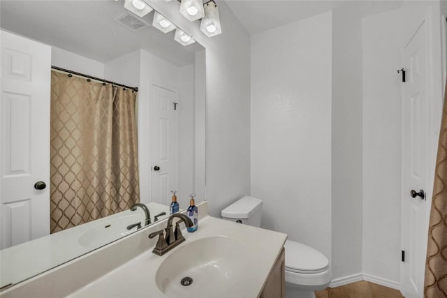 bathroom with toilet, visible vents, tile patterned flooring, and vanity