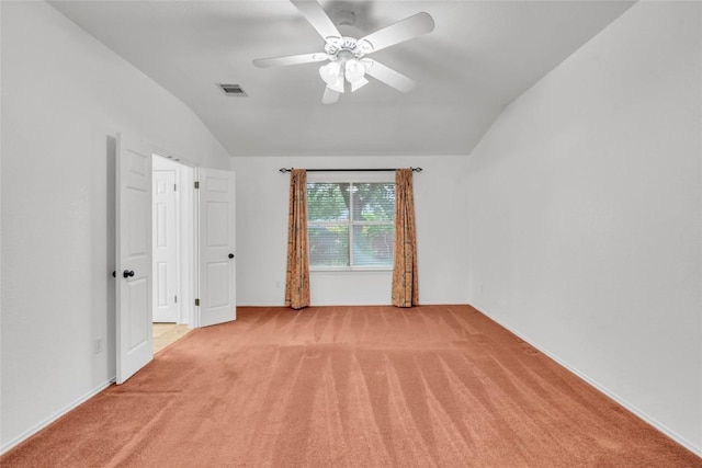 unfurnished bedroom featuring visible vents, baseboards, vaulted ceiling, and light colored carpet
