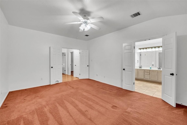 unfurnished bedroom with baseboards, light carpet, and visible vents