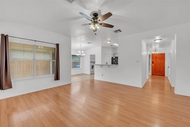 unfurnished living room with washer / clothes dryer, visible vents, baseboards, ceiling fan with notable chandelier, and light wood-style floors