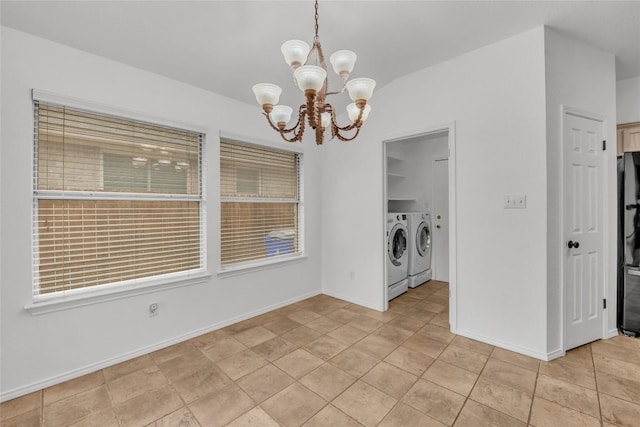 unfurnished dining area featuring separate washer and dryer, baseboards, and a chandelier