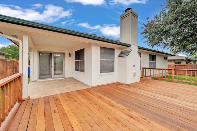 wooden terrace featuring fence
