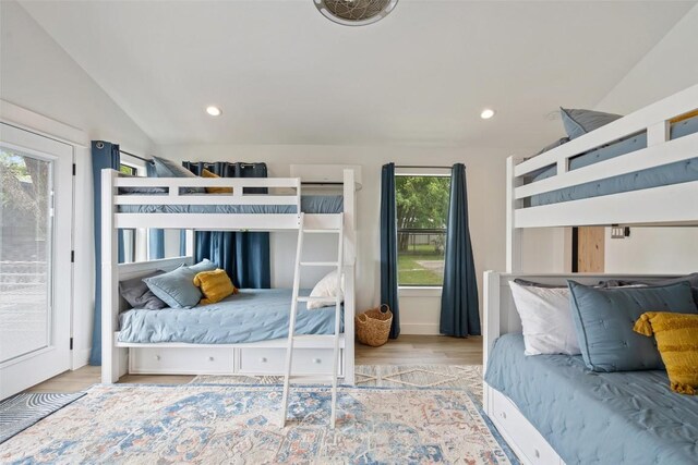 bedroom with recessed lighting, vaulted ceiling, access to exterior, and wood finished floors