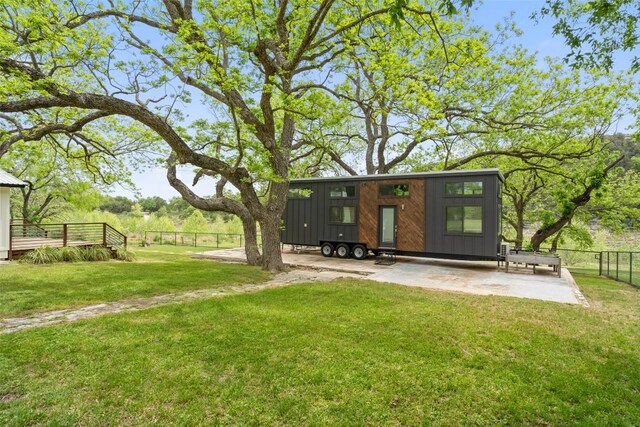 view of yard with a patio, fence, and a wooden deck
