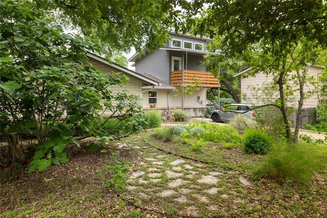 rear view of property featuring a balcony