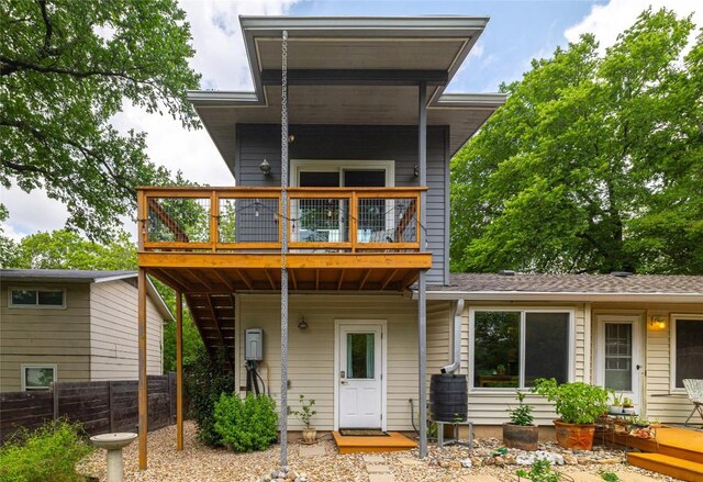 rear view of house with stairs, a shingled roof, fence, and a deck