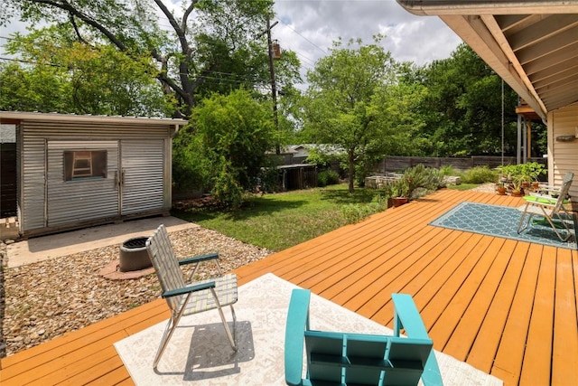 wooden deck with a lawn, a fenced backyard, and a patio