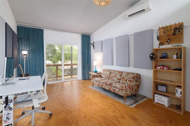 office with wood finished floors, a wall mounted air conditioner, and lofted ceiling