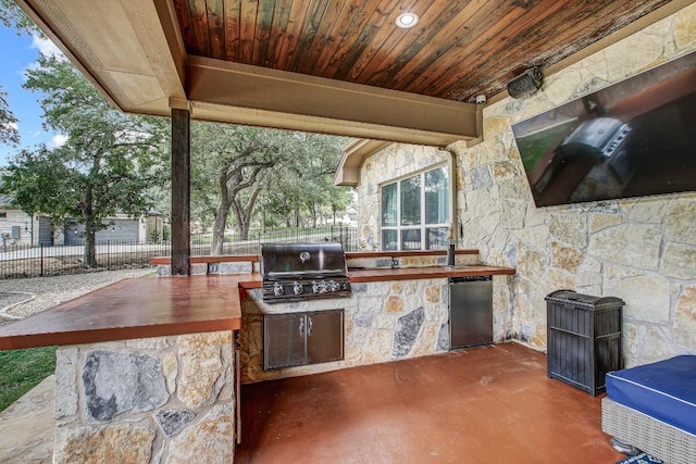 view of patio with fence and area for grilling